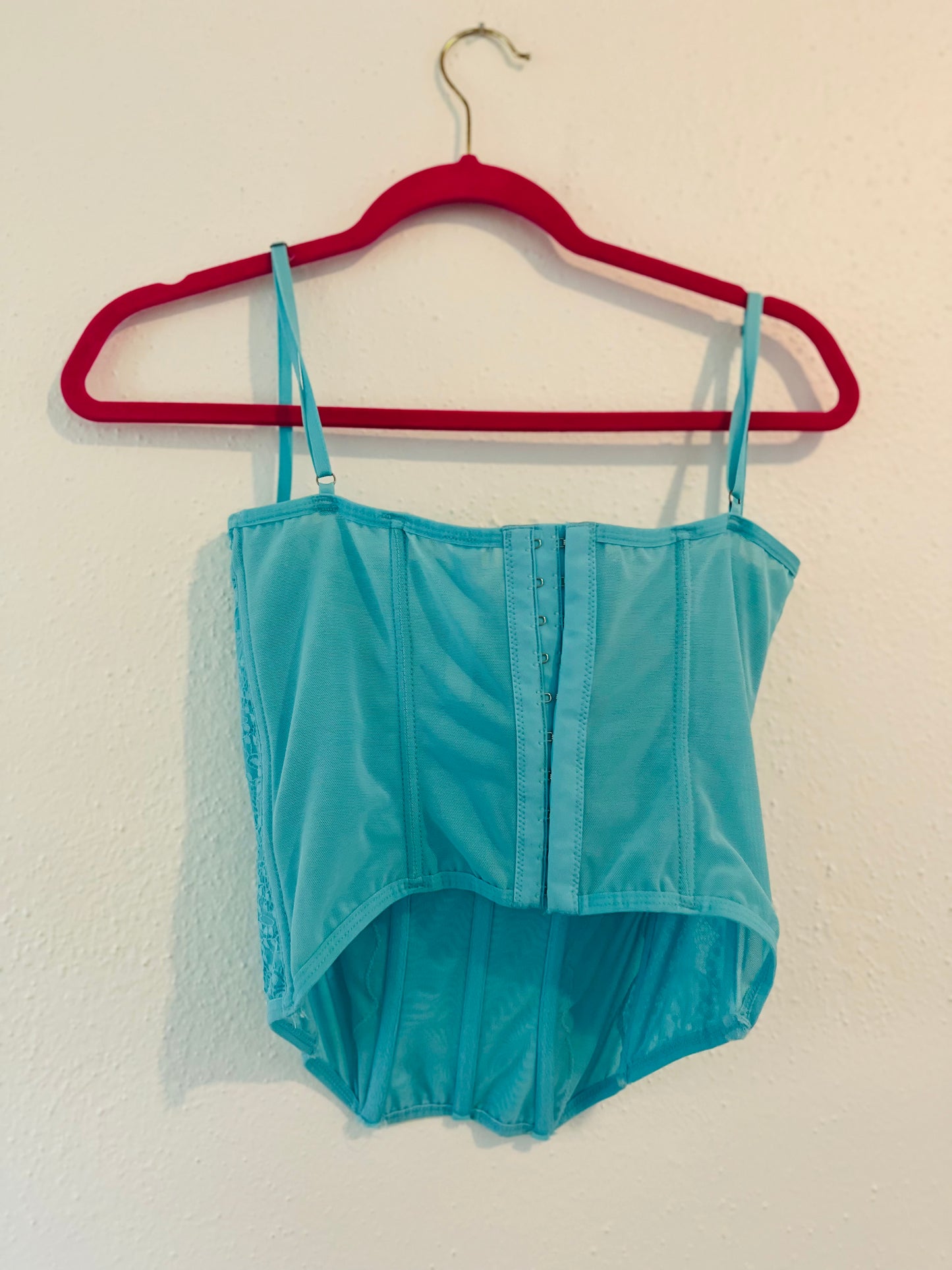 Out from under blue corset
