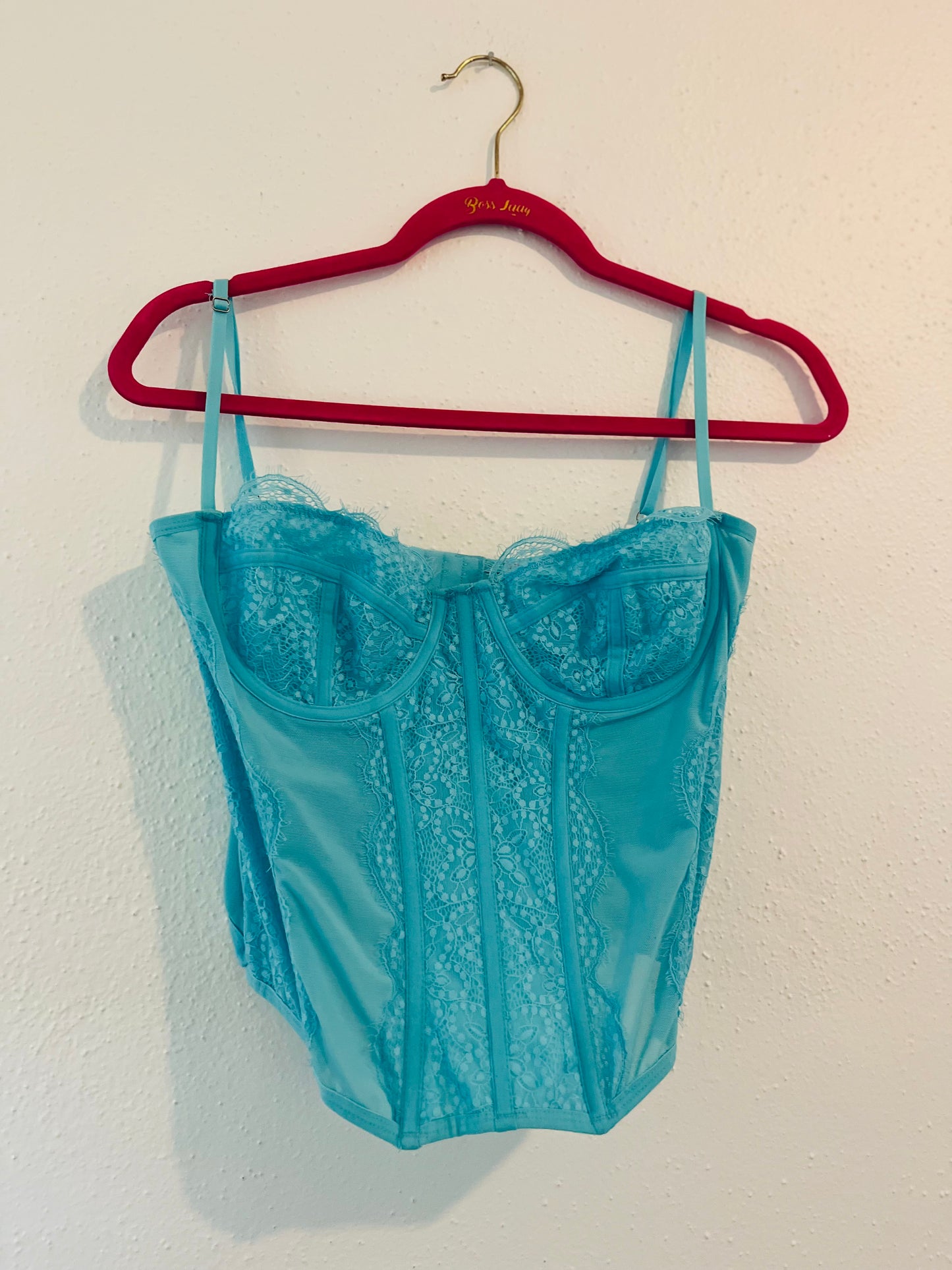 Out from under blue corset