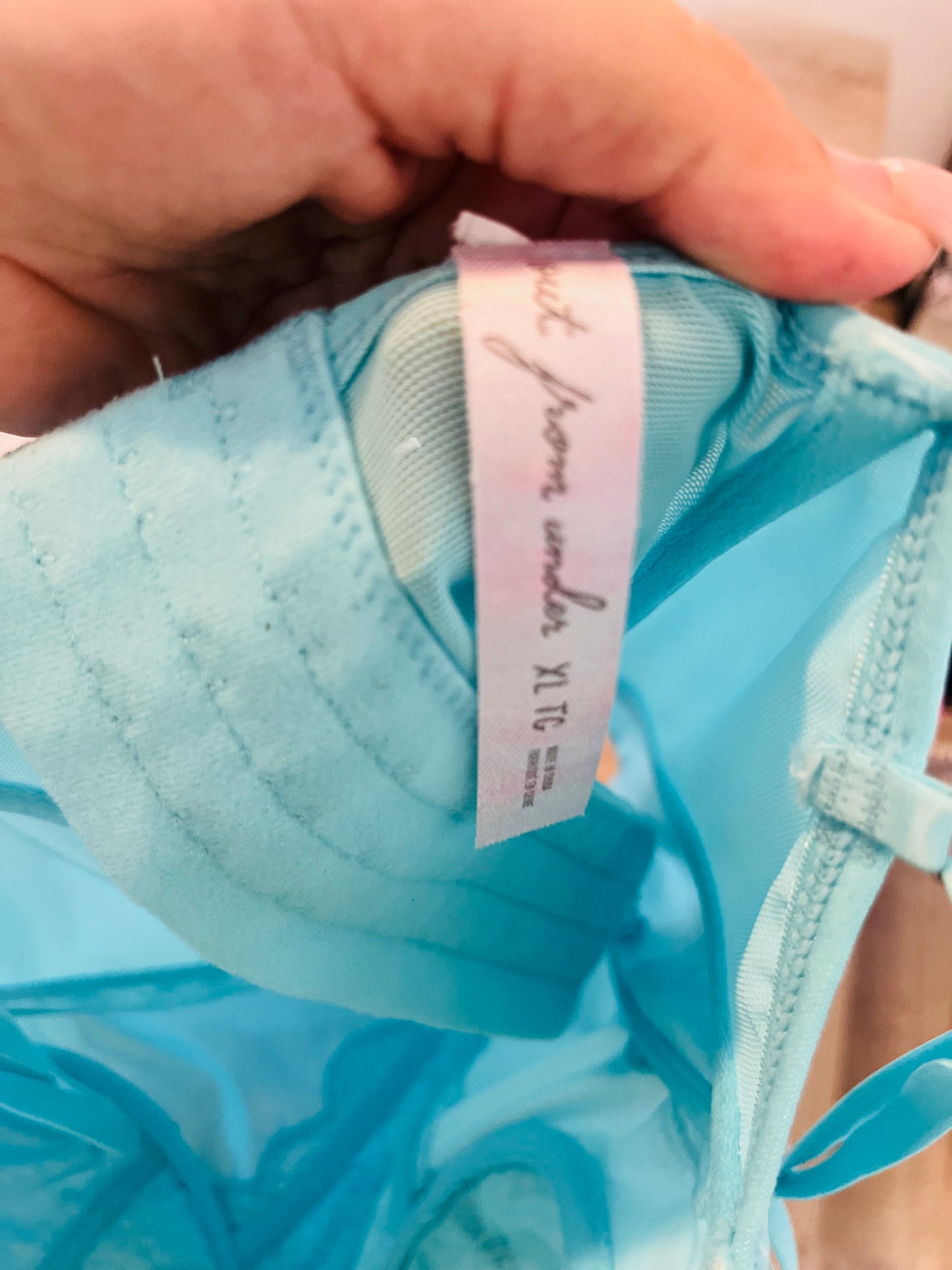 Out from under blue corset